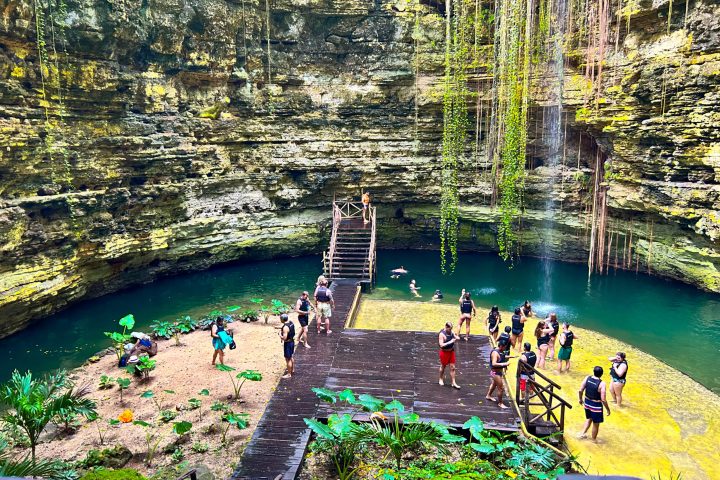 a group of people sitting around a pond