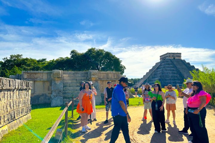 a group of people that are standing in the grass