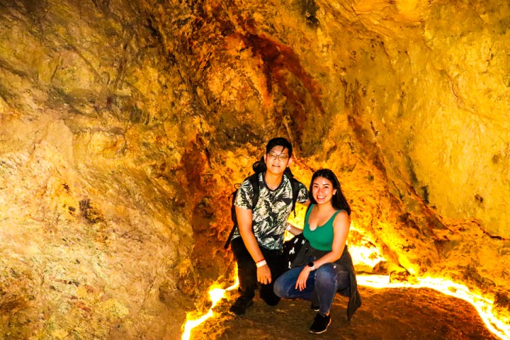 a person standing in front of a cave