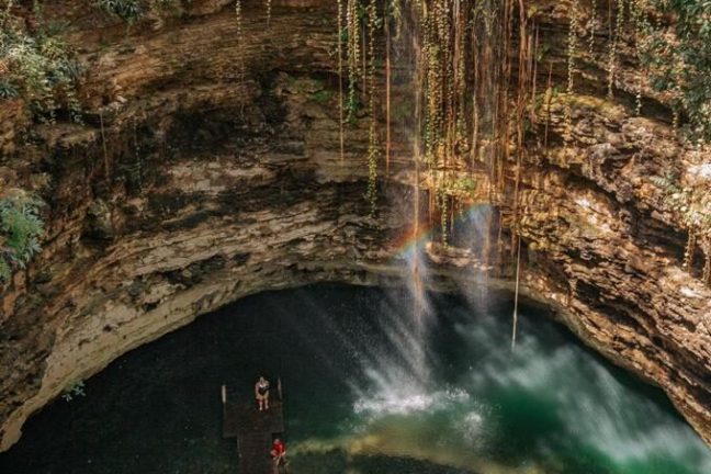a large waterfall in a forest