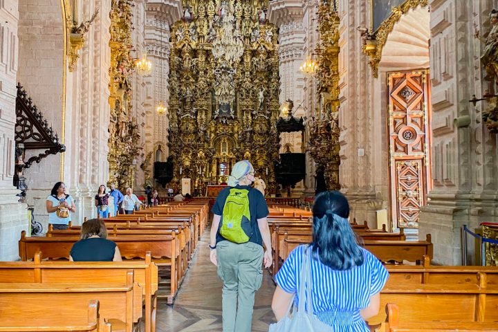 a person sitting on a bench in front of a building