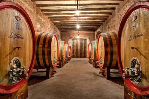 a barrel sitting next to a large mirror
