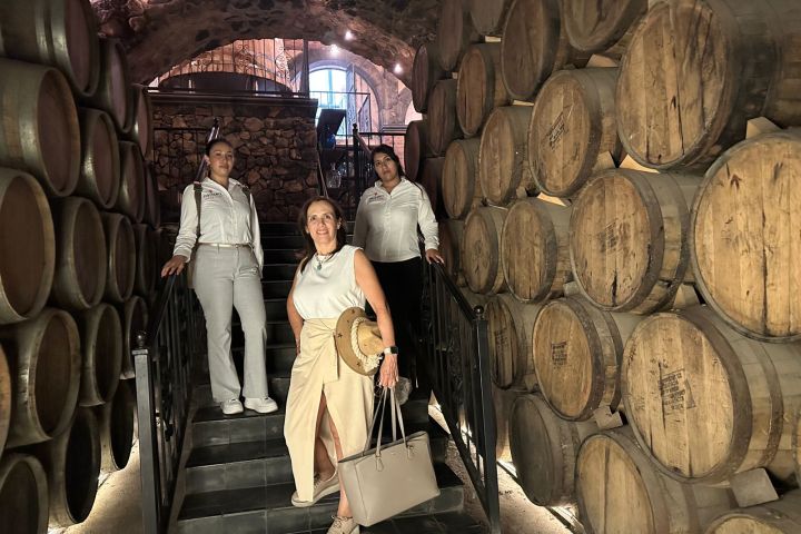 a group of people standing in front of a barrel