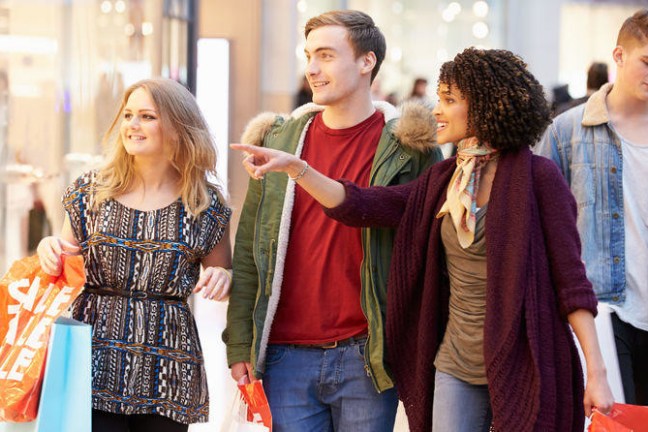 a group of people standing next to a woman