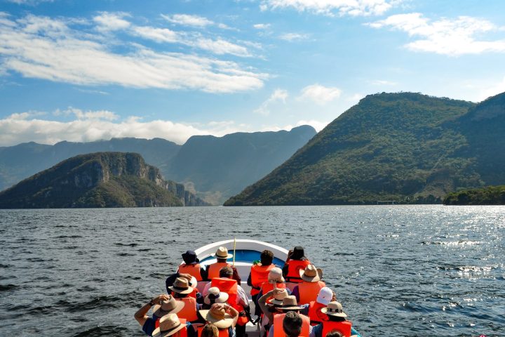 a group of people in a boat on a body of water