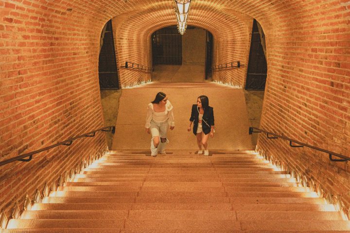 a person standing in front of a brick building