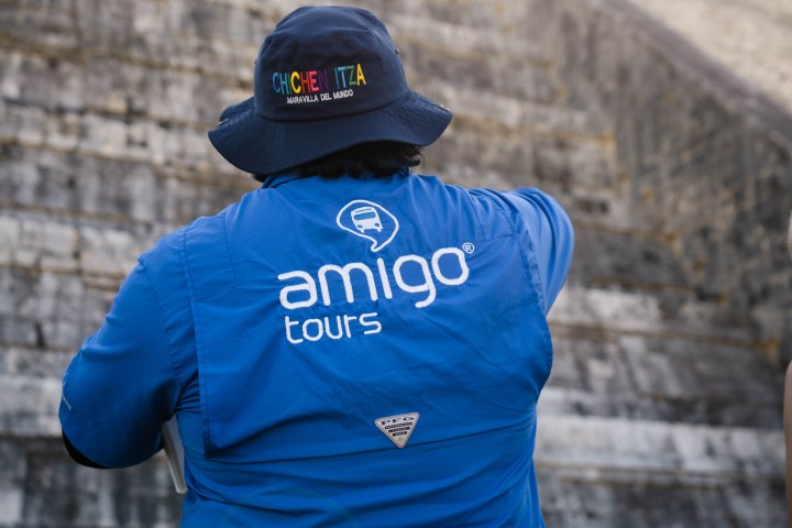 a person standing in front of a brick building