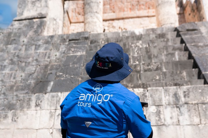 a person standing in front of a brick building