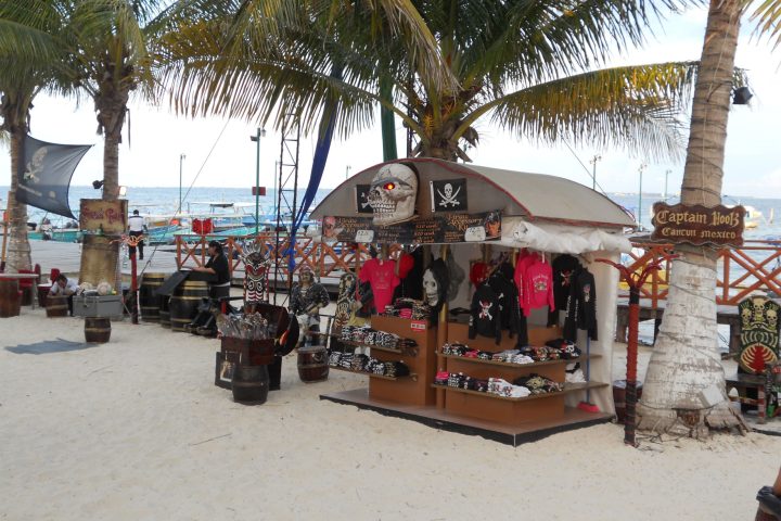 a group of people standing next to a palm tree