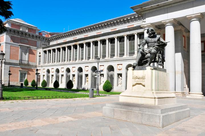 a large stone statue in front of Museo del Prado