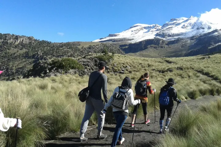 a group of people standing on top of a mountain