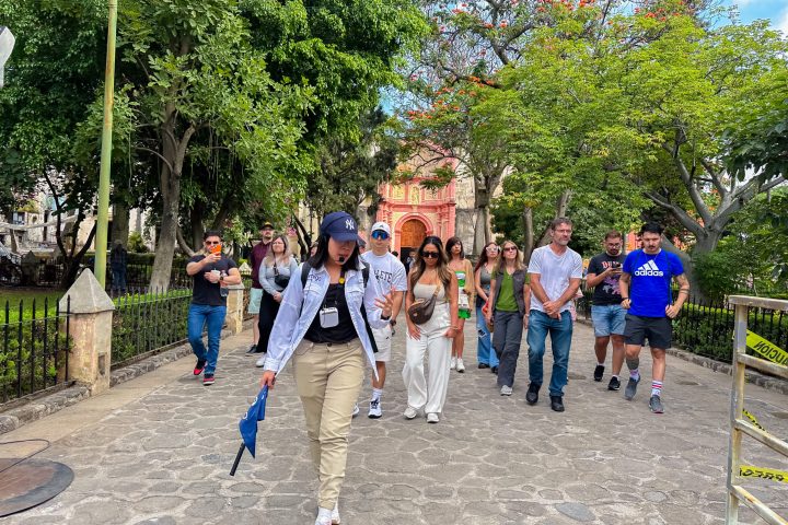 a group of people walking down a dirt road