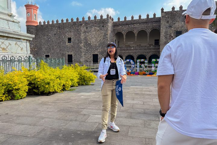 a man and a woman standing in front of a building