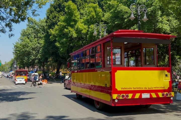 a passenger bus that is parked on the side of a road