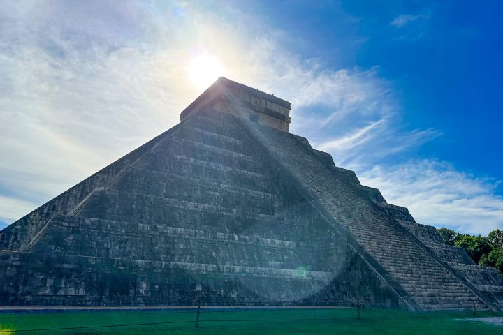 a large building with a mountain in the background
