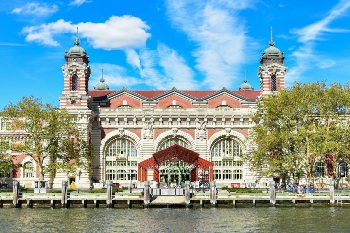 Ellis Island over a river in front of a building