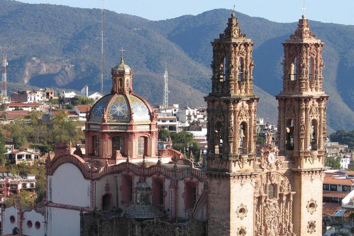 a large building with a mountain in the background