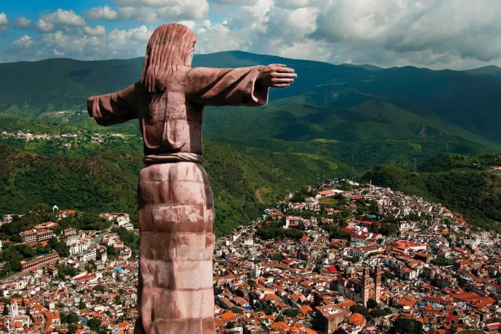 a man standing in front of a mountain