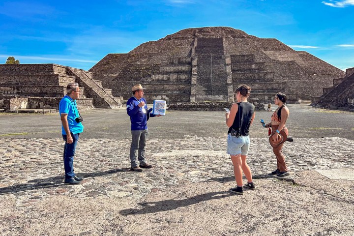 a group of people standing on top of a mountain