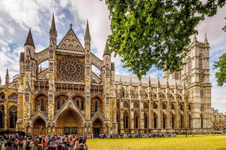 a group of people in front of a large church with Westminster Abbey in the background
