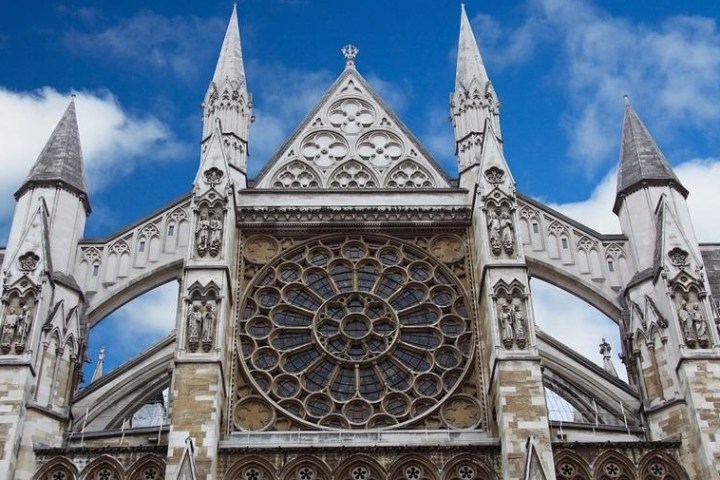 a church with a large clock tower in front of a building