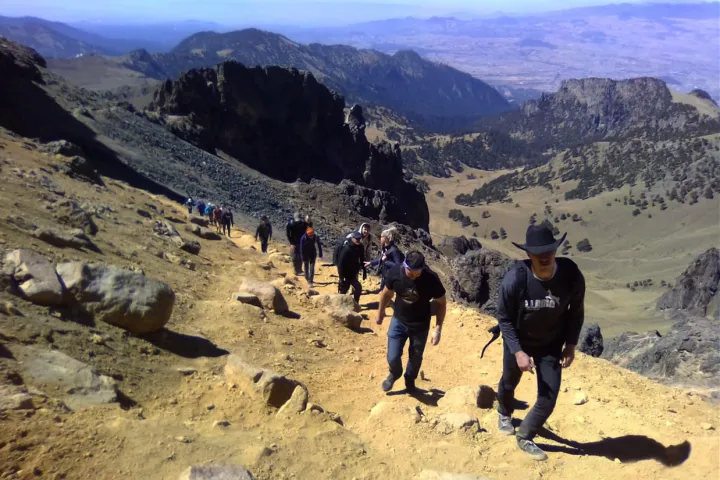 a group of people standing on top of a mountain