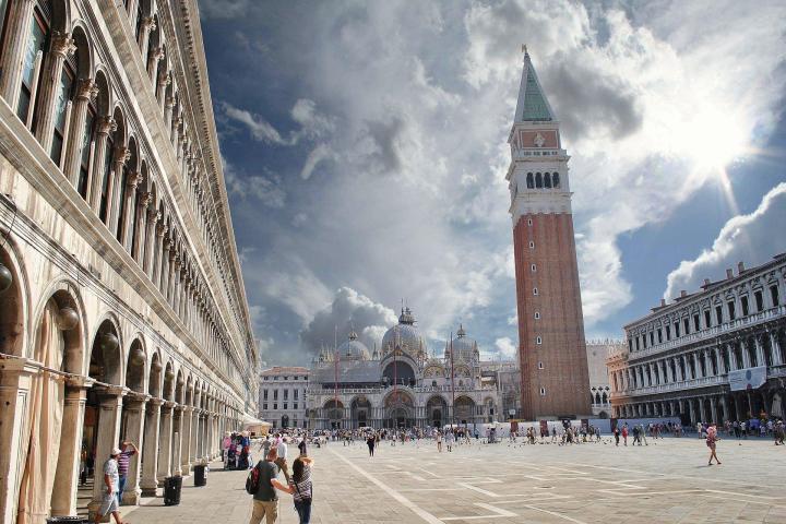 a group of people walking in front of Piazza San Marco