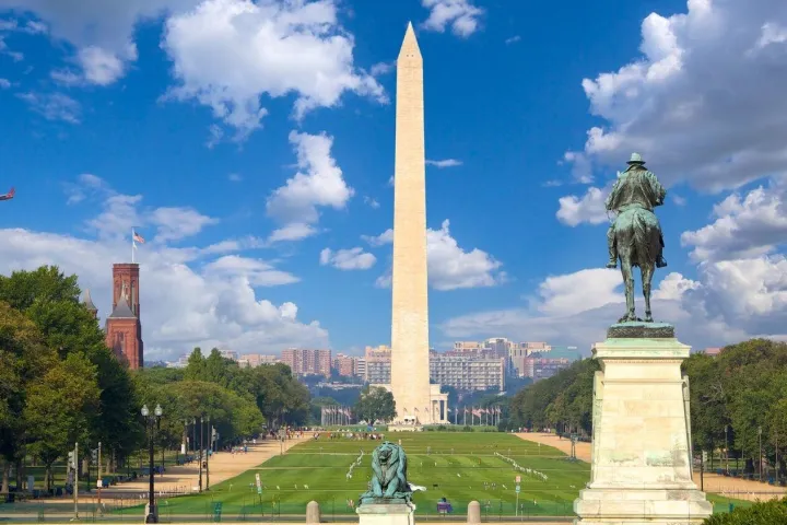 a small clock tower in the middle of a park