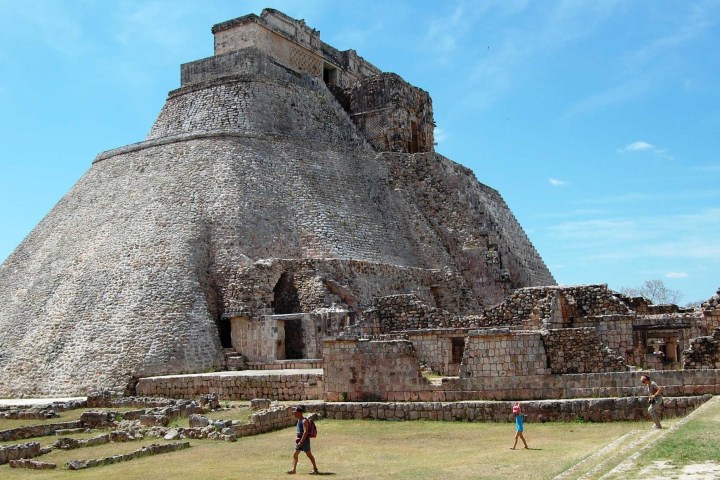 a group of people standing in front of a stone building