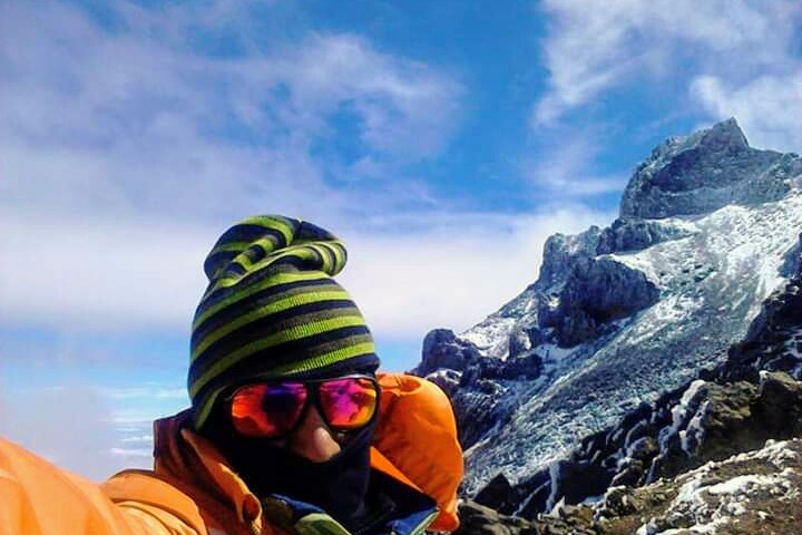 a man standing on top of a snow covered mountain