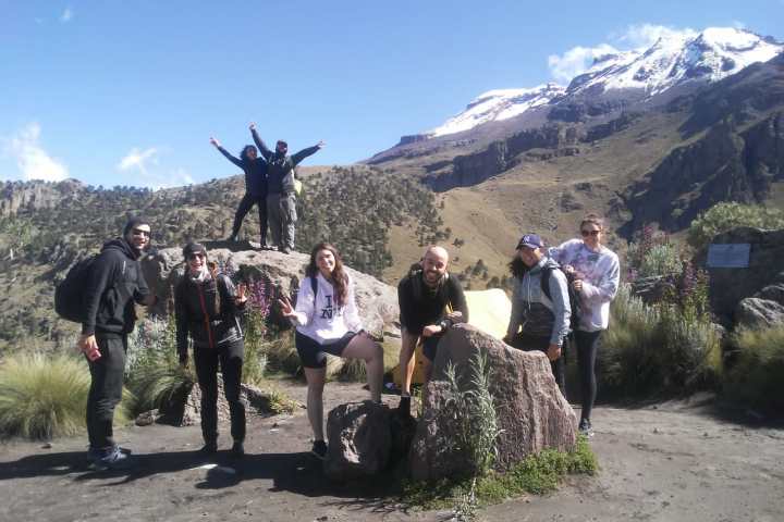 a group of people standing on top of a mountain