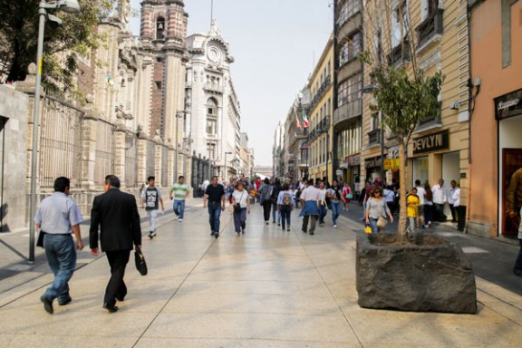 a group of people walking on a city street