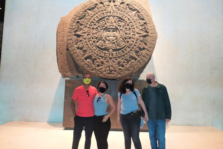 a group of people standing in front of a statue