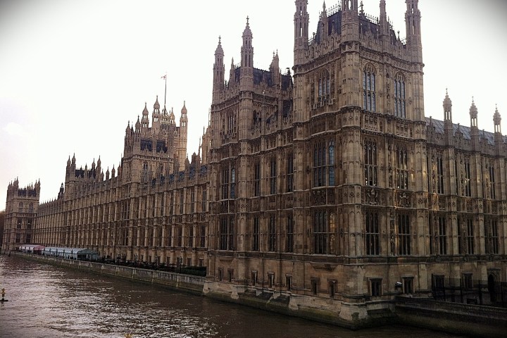 a castle with water in front of a building