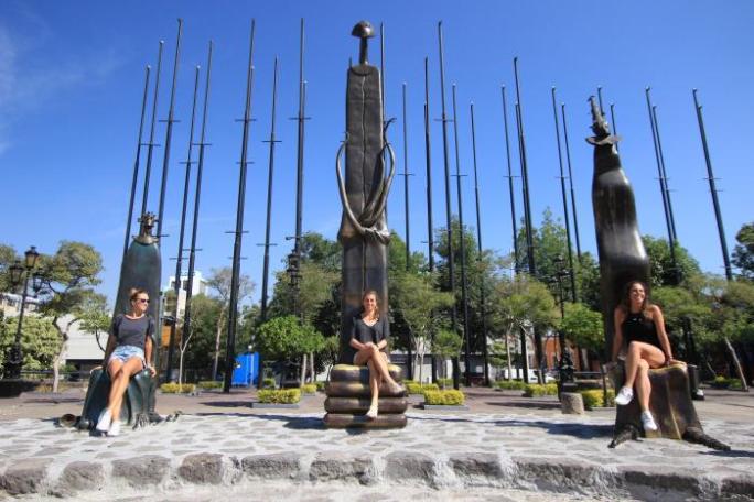 a group of people standing next to a river