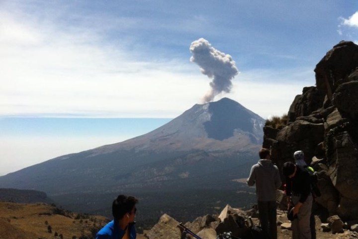 a group of people standing on top of a mountain