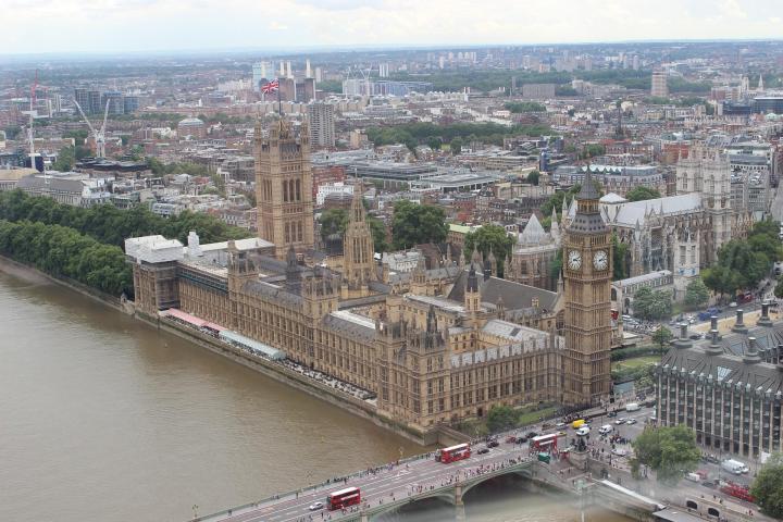 a bridge over a body of water with a city in the background