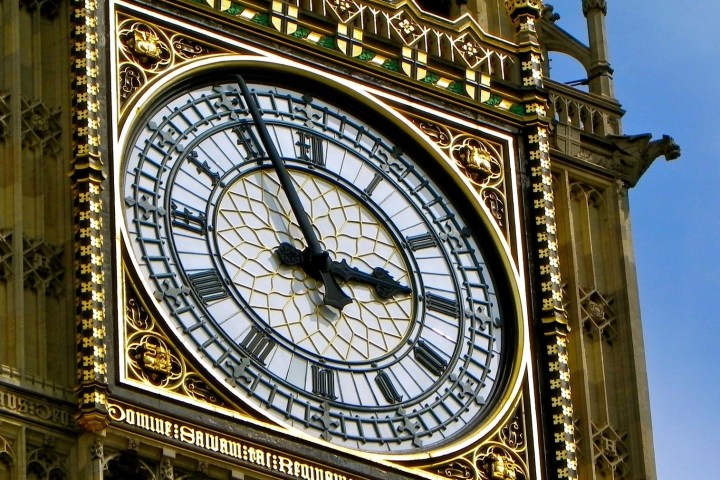 a large tall tower with a clock on the side of Big Ben