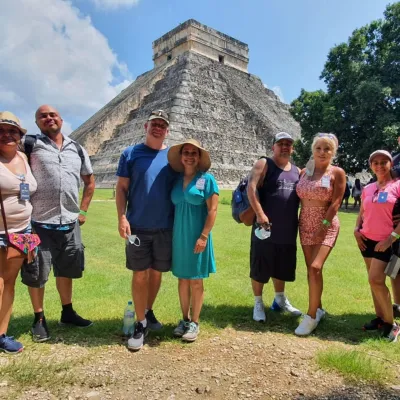 a group of people that are standing in the grass
