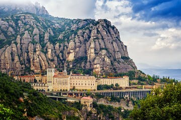 a large tower with Montserrat in the background