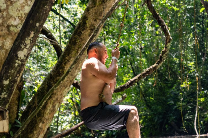 a man standing next to a tree