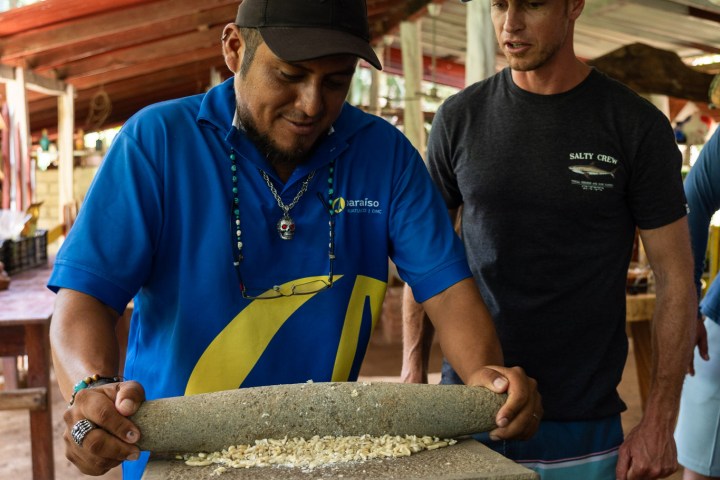 a group of people standing in front of a cake
