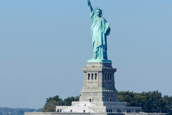 a large clock tower in the middle of a body of water