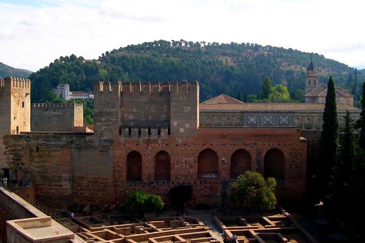a castle like building with a mountain in the background