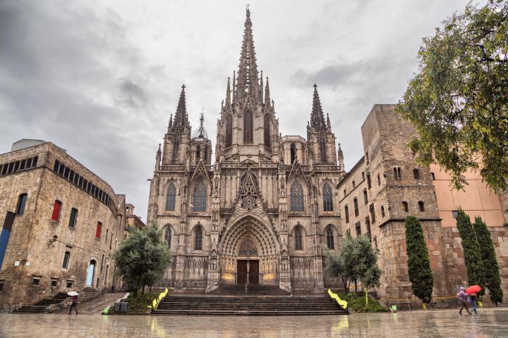 a group of people in front of a large church with Barcelona Cathedral in the background