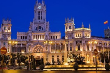 a large building with Plaza de Cibeles in the background