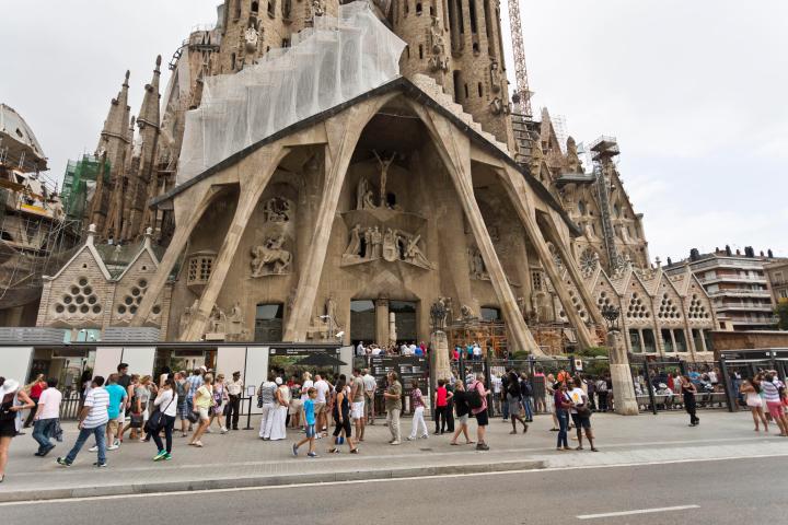 a group of people walking in front of a building