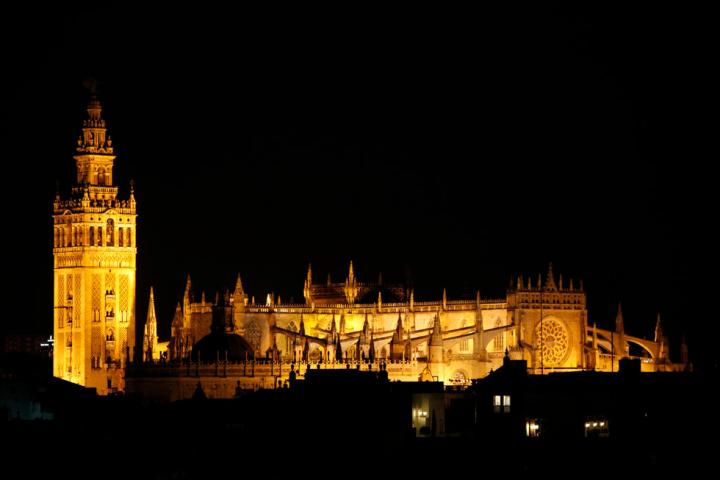 a large clock tower towering over a city at night
