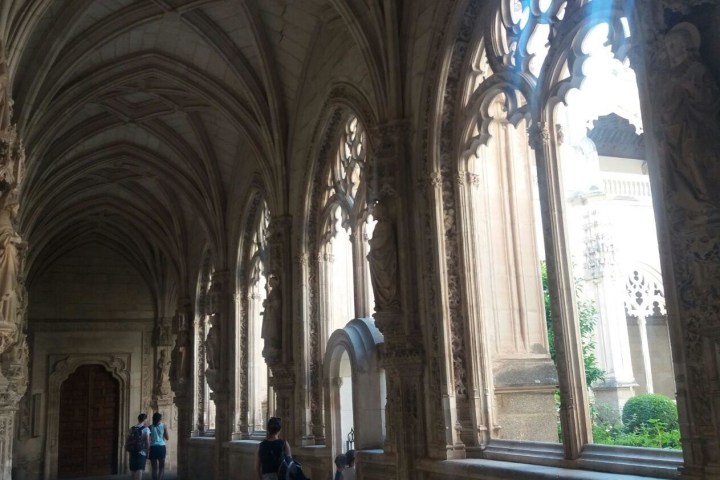 a large stone statue in front of a window