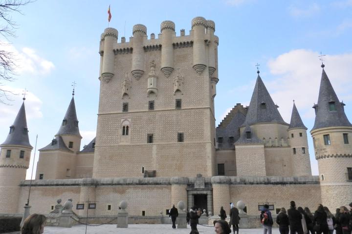 a group of people standing in front of a castle